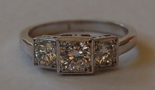 A lady's 18ct white gold dress/engagement ring set 3 circular cut diamonds contained in square mounts approx. 0.95ct