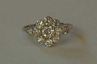 A lady's  18ct white gold cluster dress ring set numerous diamonds and 2 diamonds to the shoulders approx. 1.10ct
