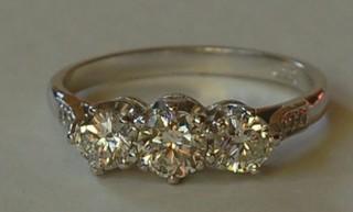 A lady's 18ct white gold dress/engagement ring set 3 diamonds and having 6 diamonds to the shoulders, approx. 1.05ct