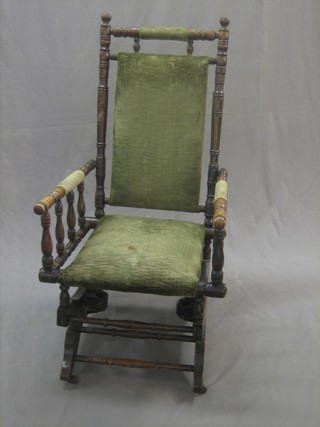 A Victorian carved beech American rocking armchair