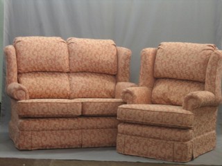 A good quality modern 2 seat settee and matching armchair upholstered in orange material