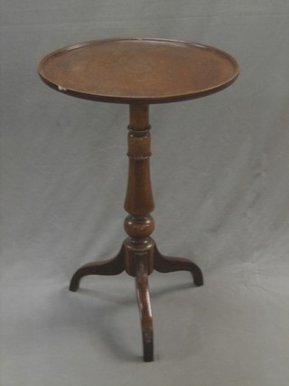 A 19th Century circular mahogany wine table raised on a turned column and tripod base 19"