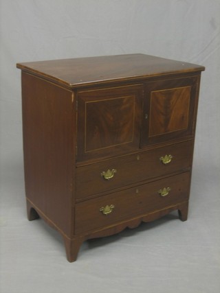 A Georgian mahogany commode the upper section fitted a cupboard enclosed by a panelled door, the base fitted 2 long drawers 25"