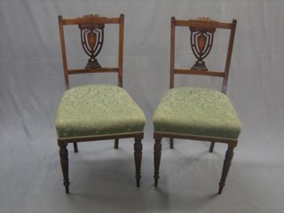A set of 4 Edwardian inlaid rosewood shield back bedroom chairs with upholstered seats, raised on turned supports