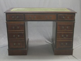 A Georgian style mahogany kneehole pedestal desk with inset tooled leather writing surface, above 1 long and 8 short drawers, raised on a pedestal base 48"