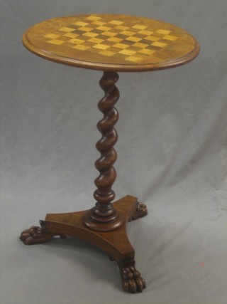 A circular William IV mahogany games table, the top inlaid a chessboard, raised on a spiral turned column with triform base ending in paw feet 20"