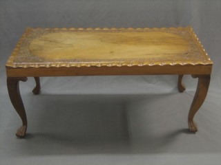 A rectangular carved Burmese occasional table, raised on cabriole supports 40"