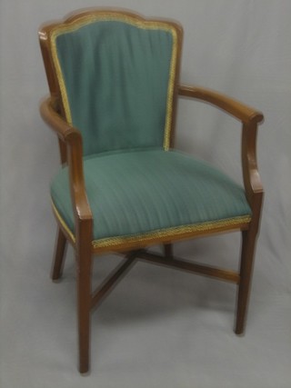 An Empire style mahogany open arm chair with X framed stretcher, raised on square tapering supports