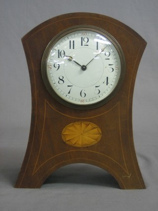 A mantel time piece with enamelled dial and Arabic numerals contained in an arched inlaid mahogany case