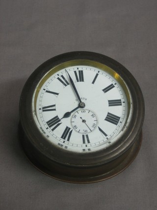 An 8 day car clock with circular enamelled dial and subsidiary second hand, contained in a brass case 2 1/2"