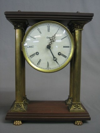 A reproduction 19th Century striking Portico clock with paper dial and Roman numerals contained in a gilt metal and mahogany case with Corinthian columns 11"