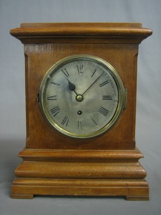 A Victorian fusee bracket clock with 5 1/2" circular silvered dial and Roman numerals, having a 4 1/2" plain brass back plate, contained in a honey oak case