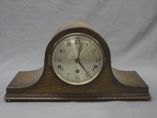 A 1930's chiming mantel clock with silvered dial and Arabic numerals contained in an oak Admiral's hat shaped case