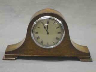 A 1930's bedroom timepiece with enamelled dial and Roman numerals contained in an oak Admiral's hat shaped case by Mappin & Webb