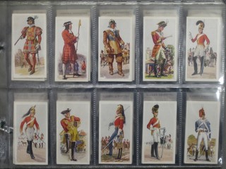 Carreras Cigarette cards set 1-50 - History of Army Uniforms, Players set 1-50 - Military Head-Dress, Morning Foods Ltd Mornflake cereal cards set 1-25 - British Uniforms, Mills set 1-25 - British Uniforms of the 19th Century, Morris's 4 out of a set of 25 - A Series of War Pictures, Player's  49 out of a set 50 - Regimental Colours, do. (blue backs) set 1-50 - Regimental Colours,   do. 46 out of a set of 50 (blue backs) - Regimental Colours and Cap Badges, Walters "Palm" Toffee cards set 1-50 - Some Cap Badges of Territorial Regiments, Players set 1-50 - Badges & Flags of British Regiments (brown backs), and Player's 49 out of a set of 50 - Badges & Flags of British Regiments (green backs)