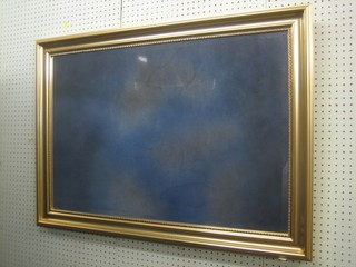 A rectangular bevelled plate wall mirror contained in a gilt frame 40"