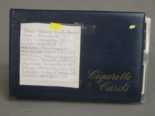 A blue album of various cigarette cards