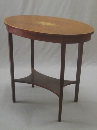 An Edwardian oval mahogany occasional table, the top with inlaid shell decoration, raised on square tapering supports with undertier 29"