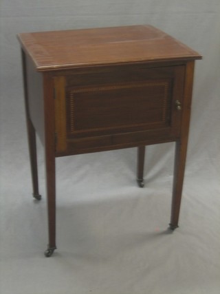 An Edwardian rectangular inlaid mahogany bedside cabinet enclosed by a panelled door, raised on square tapering supports 22"