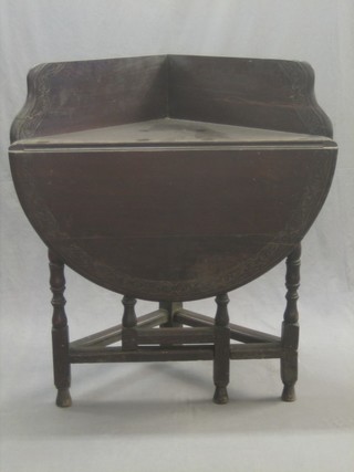 A Victorian carved oak drop flap corner gateleg table with raised back 34"