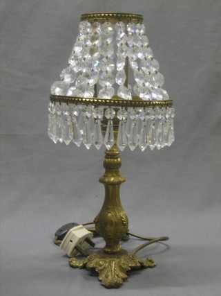 A gilt metal table lamp with a cut glass lozenge shade