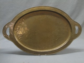 An oval planished copper twin handled tea tray 25"