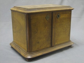 A Victorian walnut table top cabinet fitted 2 drawers enclosed by panelled doors and raised on bun feet 11"