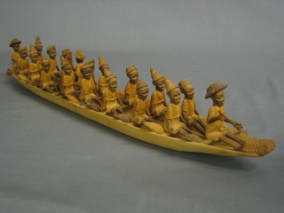 An Eastern carved model boat containing various figures 20"