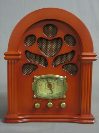 A 1930's style radio contained in an arch shaped mahogany case