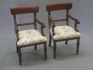 A pair of child's Georgian style mahogany bar back carver chairs raised on turned and fluted supports