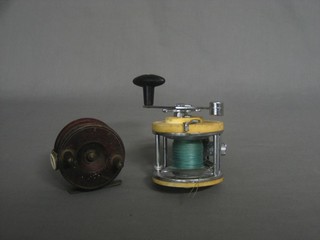 A Mitchell 606 fishing reel and a centre pin fishing reel 3"