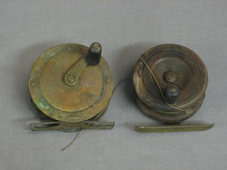 A brass fishing reel 2 1/2" and a wooden brass fishing reel 2 1/2"