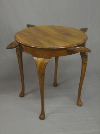 A circular Queen Anne style walnut games table, the base fitted gaming counter wells, raised on cabriole supports 27"