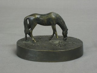 A 19th Century bronze paperweight in the form of a grazing horse, raised on an oval base 4" (f)