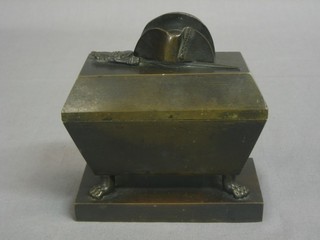A 19th Century bronze sarcophagus shaped twin compartment inkwell, the interior fitted 2 recesses, the lid with cocked hat and sword 4"