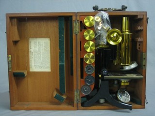 A single pillar microscope by J Swift & Sons contained in a mahogany case, together with 7 various lenses 