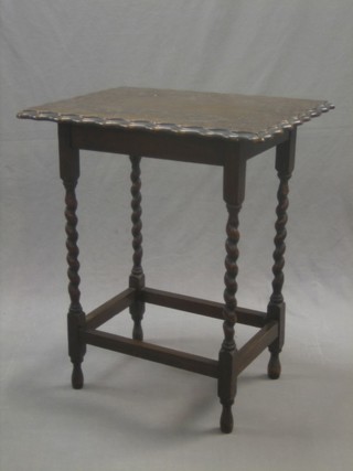 A rectangular carved oak table with pie crust decoration, raised on spiral turned supports 24"