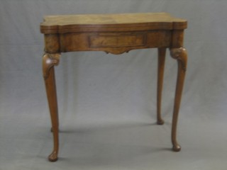A 1930's Queen Anne style shaped figured walnut card table with crossbanded top, raised on cabriole supports 30"
