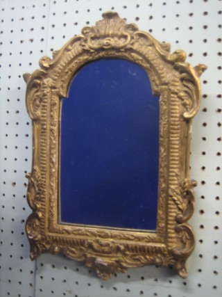 An arched plate mirror contained in a gilt painted plaster frame 14"