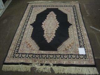 A black and brown ground Persian rug with central medallion within multi-row borders 65" x 48"