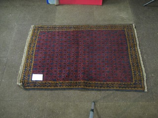 A contemporary red ground Persian Belouch rug 48" x 32"