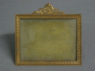 A gilt metal easel photograph frame 5" x 7 1/2"