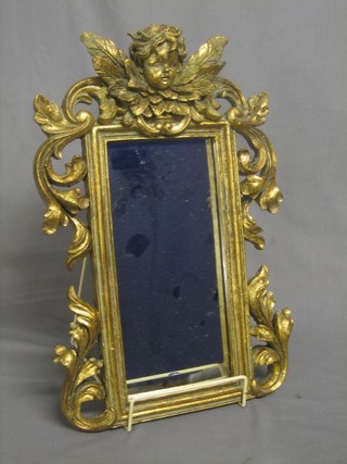 A rectangular plate mirror contained in a gilt frame surmounted by a figure of a cherub 17" x 9"