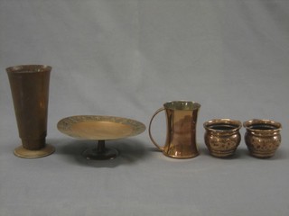 A cylindrical waisted copper vase 8", a circular copper tazza 8", a pair of copper vases and a copper tankard