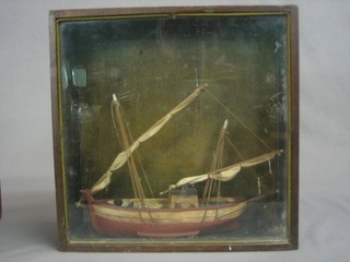 A wooden model of a fishing boat contained in a glazed case 10"