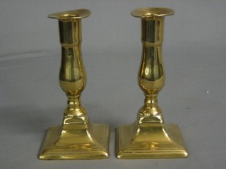 A pair of 19th Century brass candlesticks raised on square bases 6"