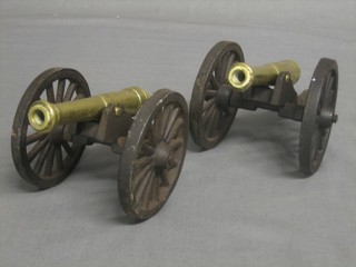 A pair of brass and iron models of canons with 5" brass barrels