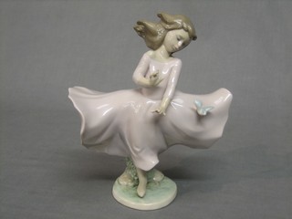 A Lladro figure of a standing girl with bird, base impressed 6412 8 1/2"