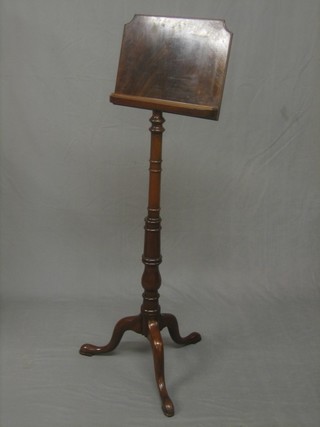 A reproduction 19th Century inlaid mahogany music/reading stand, raised on a pillar and tripod support