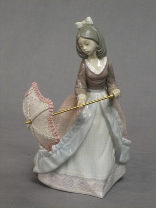 A Lladro figure of a lady with parasol, base marked 5210 7"